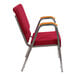 A Flash Furniture burgundy church chair with silver frame and wood accents on the arms.