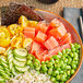 A bowl of Beleaf vegan tuna sashimi with rice and vegetables on a table.