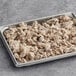 A baking pan filled with PAOW! Plant-Based Beef Dark Pieces on a table.