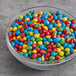 A bowl of 4M Rainbow Sugar Shell Cocoa Drops.