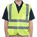 A man wearing a Cordova lime yellow high visibility safety vest.