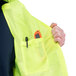 A man wearing a Cordova lime high visibility safety vest with a pen in the pocket.