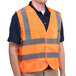 A Cordova orange high visibility safety vest with reflective stripes.