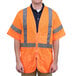 A man wearing a Cordova orange high visibility safety vest with reflective stripes.