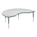 A white Correll kidney-shaped activity table with a green edge.