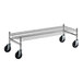 A Regency stainless steel wire dunnage rack with black wheels.