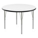 A Correll round activity table with a white top, black edge, and silver legs.