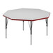 A white hexagon table with black legs and red trim.