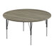 A Correll round activity table with black metal legs and a New England driftwood top.