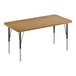A rectangular wooden table with medium oak and black legs.