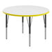 A white activity table with yellow T-mold and black legs.