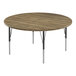 A round wooden table with black metal legs.