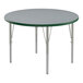 A Correll round table with a gray and green top and metal legs.