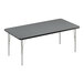 A rectangular table with a black and grey top and silver legs.