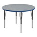 A round Correll activity table with a gray granite top and black legs.