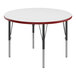 A white round Correll activity table with red edges and black legs.