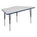 A white trapezoid activity table with blue T-mold on the edges and black legs.