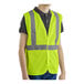 A person wearing a lime high visibility safety vest.