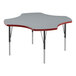A close-up of a grey high-pressure laminate activity table with black legs and red t-mold.