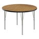 A Correll round activity table with a medium oak top and silver legs.