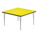 A yellow square table with silver legs and black edge.