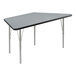 A grey trapezoid table with silver legs and black edge.