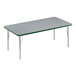 A rectangular Correll activity table with a gray surface, green edge, and silver legs.