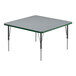 A square gray activity table with black legs and a green edge.