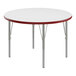 A white round Correll activity table with red edges.