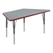 A grey Correll trapezoid activity table with black legs and red T-mold.