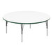 A white Correll round activity table with a green rim and metal legs.