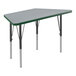 A grey and green trapezoid-shaped Correll activity table with black legs.