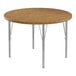 A close-up of a Correll round wooden activity table with silver legs.