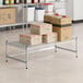 A group of white boxes on a Regency stainless steel wire shelf.