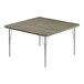 A square Correll activity table with metal legs and a gray top with driftwood trim.