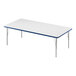 A white rectangular Correll activity table with metal legs and blue T-mold