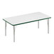 A Correll rectangular white activity table with silver legs and green T-mold.