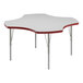 A white table with a red clover-shaped top and red trim on white table legs.