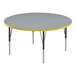 A grey round Correll activity table with yellow trim.