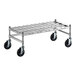 A Regency stainless steel wire mobile dunnage rack with black wheels.