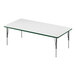 A Correll rectangular white activity table with metal legs and a green edge.