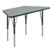 A grey trapezoid Correll activity table with black legs and green T-mold.
