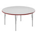 A white round Correll activity table with red edges.