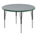 A Correll round activity table with gray granite top and black legs with green trim.