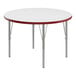 A white round Correll activity table with red edges.