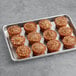 A tray of Veggies Made Great Cinnamon Roll Muffins on a gray surface.