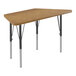 A trapezoid shaped Correll activity table with medium oak top and black legs.