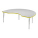 A white Correll activity table with a yellow edge in a curved shape.