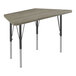 A trapezoid-shaped table with black metal legs and a driftwood top.