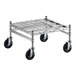 A Regency stainless steel wire mobile dunnage rack with black wheels.